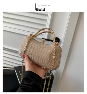 Detail of gold glitter evening clutch bag with round handle and rhinestone clasp