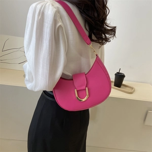 Chic rose red crescent shoulder bag with golden D-ring buckle on a minimalist background