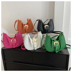 Detail of five croc-patterned shoulder bags with vintage golden baroque buckles