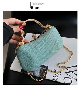 Detail of light blue sequin evening bag with gold handle and sparkling clasp