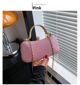 Pink glitter evening clutch bag with gold handle and sparkling diamond clasp detail