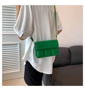 Detail view of grass green crossbody bag with unique chocolate-style textured squares