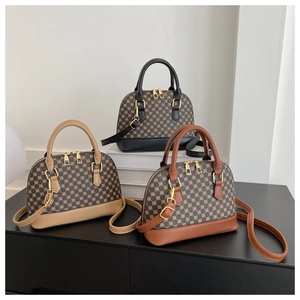 Detailed view of three vintage shell bags in black, beige and brown with geometric pattern