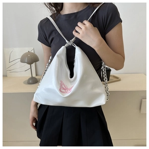 Detailed view of white PU leather hobo bag with pink butterfly embroidery and chain strap