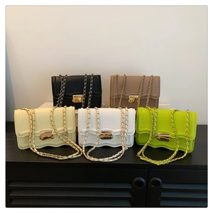 Detailed view of five colorful chain crossbody bags with elegant scalloped edge design
