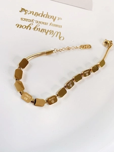 Golden snake bone bracelet featuring multiple rectangular love charms and adjustable chain