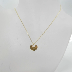 Golden Ruyi lock necklace with Fu character pendant on white jewelry mannequin