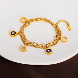 Double-layered gold titanium steel bracelet with Roman numeral charms and white shell inlay