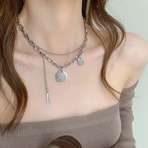Double layer silver stainless steel necklace with engraved square pendant tags on a model