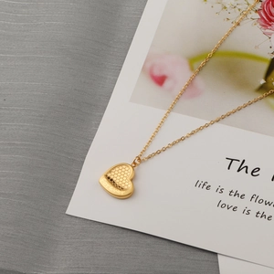 Polished gold heart necklace with honeycomb texture and Forever engraving on fine chain