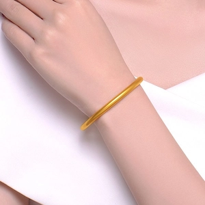 Elegant matte 18K gold plated minimalist bangle showing a classic solid round silhouette