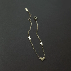 Minimalist gold plated titanium steel bracelet featuring three polished heart charms for women
