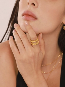 Detail of stacked 18k gold plated rings with unique hammered texture and lava texture