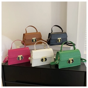 Collection of five colorful crocodile pattern handbags with gold metal twist locks