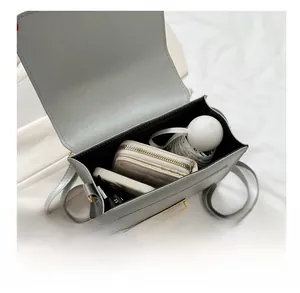 Detail view of large capacity gray backpack interior with phone, wallet and umbrella