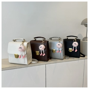 Detailed row of mini backpacks in four colors with cute pink plush charms and metal locks