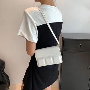 Minimalist white chocolate-box style crossbody bag with vertical quilted texture