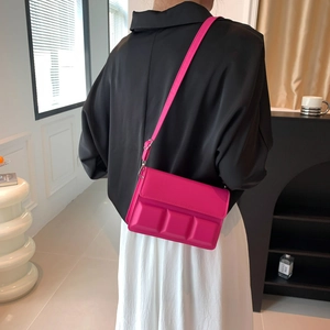 Magenta chocolate grid crossbody bag with 3D embossed texture and adjustable strap
