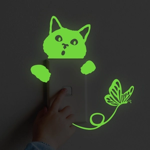 Glow in the dark cat and butterfly switch stickers showing luminous green fluorescent effect
