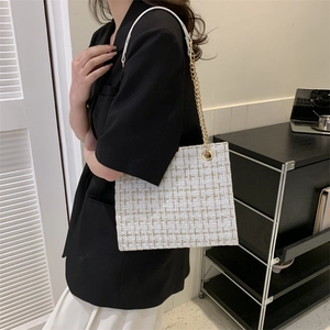 White tweed plaid tote bag with gold chain strap shown on model for daily commuting