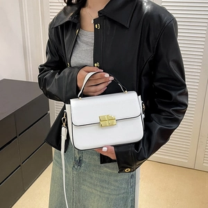 Classic white leather handbag with gold buckle and adjustable strap shown by model