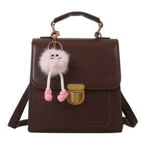 Dark brown square backpack and handbag with gold lock and pink plush monster charm