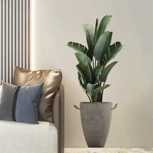 Moderne Strelitzie Kunstpflanze in grauem Topf für Wohnzimmer Hintergrunddekoration