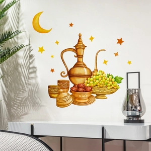 Detail of Ramadan wall stickers with golden moon, stars, and tray on white wall