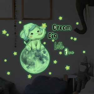 Luminous wall stickers showing a glowing elephant on the moon with Dream Big Little One text