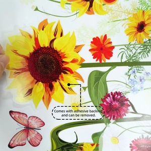Detail showing self-adhesive sunflower and butterfly wall sticker being peeled manually
