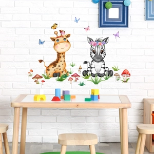 Detail of cartoon giraffe and zebra wall stickers on a white brick wall in a nursery