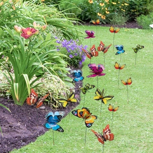 Close-up of colorful 3D double-layer butterfly garden stakes among natural green plants