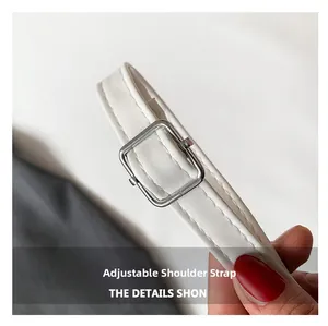 Detail of adjustable white PU leather strap with silver square buckle and stitching