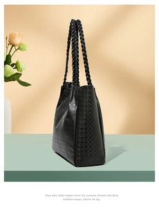 Détail du sac cabas pied-de-poule noir avec poignées tressées sur un support épuré