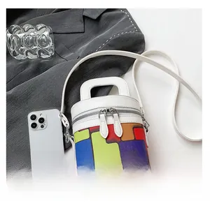 Macro shot of colorful geometric pattern and zipper on small cylindrical handbag
