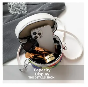 Internal view of colorful plaid bucket bag showing capacity for phone and sunglasses