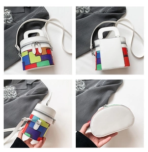 Detail view of colorful checkered pattern on white cylinder bag with metallic zippers