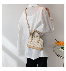 Lace straw shell bag with floral embroidery shown from the side for styling reference