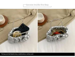 Detailed interior of the silver pleated bag showing storage space for phone and makeup