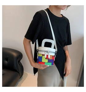 Detail of colorful geometric checkered cylinder bag with shoulder strap and handles