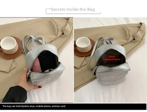 Detailed interior of a silver rhinestone mini backpack showing phone and keys storage