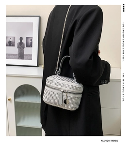 Detailed view of silver rhinestone handbag with metal chain and crystal texture