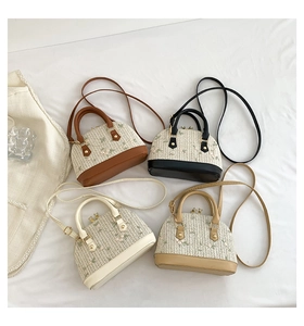 Detail of four mini straw shell bags featuring floral embroidery and leather handles