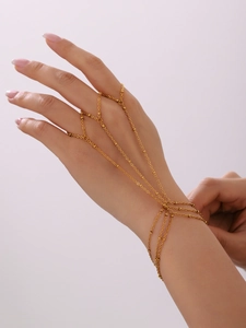 Detail of 18K gold plated beaded hand harness bracelet showing chain and ring connectivity