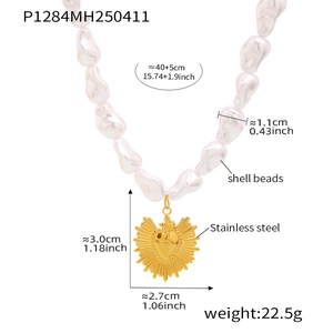 Detail of beaded necklace showing shell beads and golden stainless steel heart pendant size