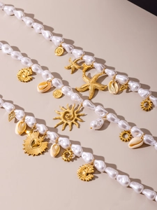 Detailed close-up of baroque pearl necklace with golden starfish and shell charms