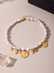 Close-up of ocean-themed baroque pearl necklace with starfish and sun pendants