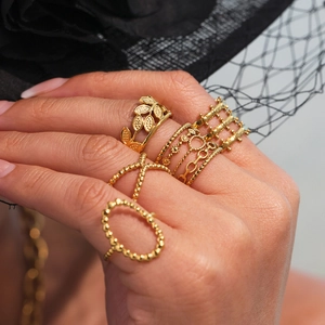 5-piece gold stackable geometric ring set with cutout and multilayered leaf designs