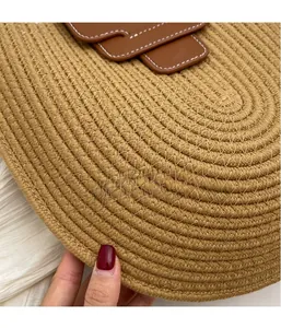 Close-up of circular woven cotton rope texture and brown leather strap on a bucket bag