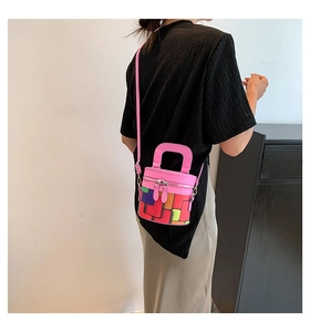 Detailed shot of mini cylindrical bucket bag with pink leather and geometric pattern